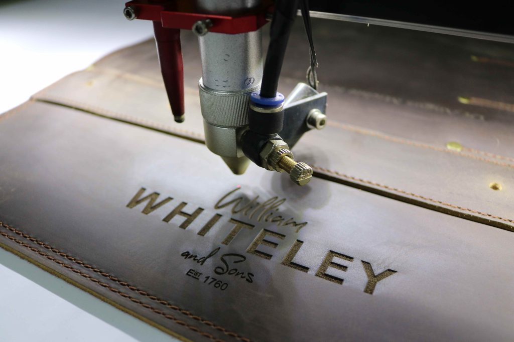 LEATHER BEING ENGRAVED WITH WILLIAM WHITELEY LOGO