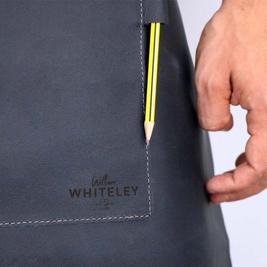 Whiteley short leather apron close up of pen holder and lasered logo