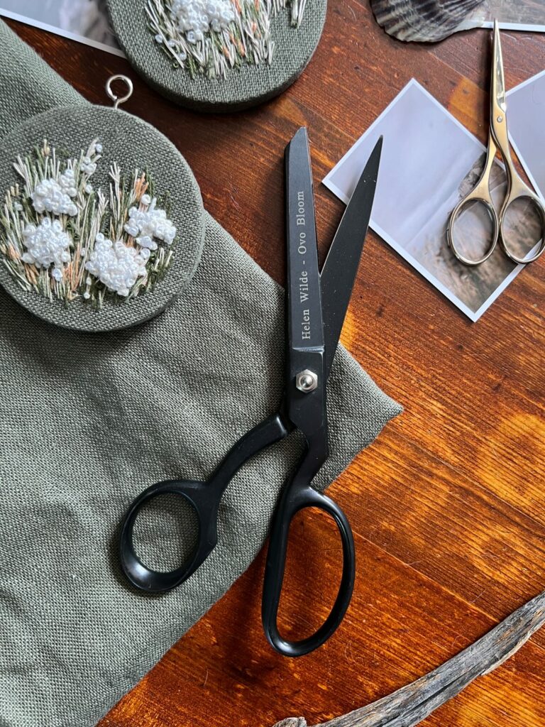 Pair of luxury scissors against a lifestyle backdrop