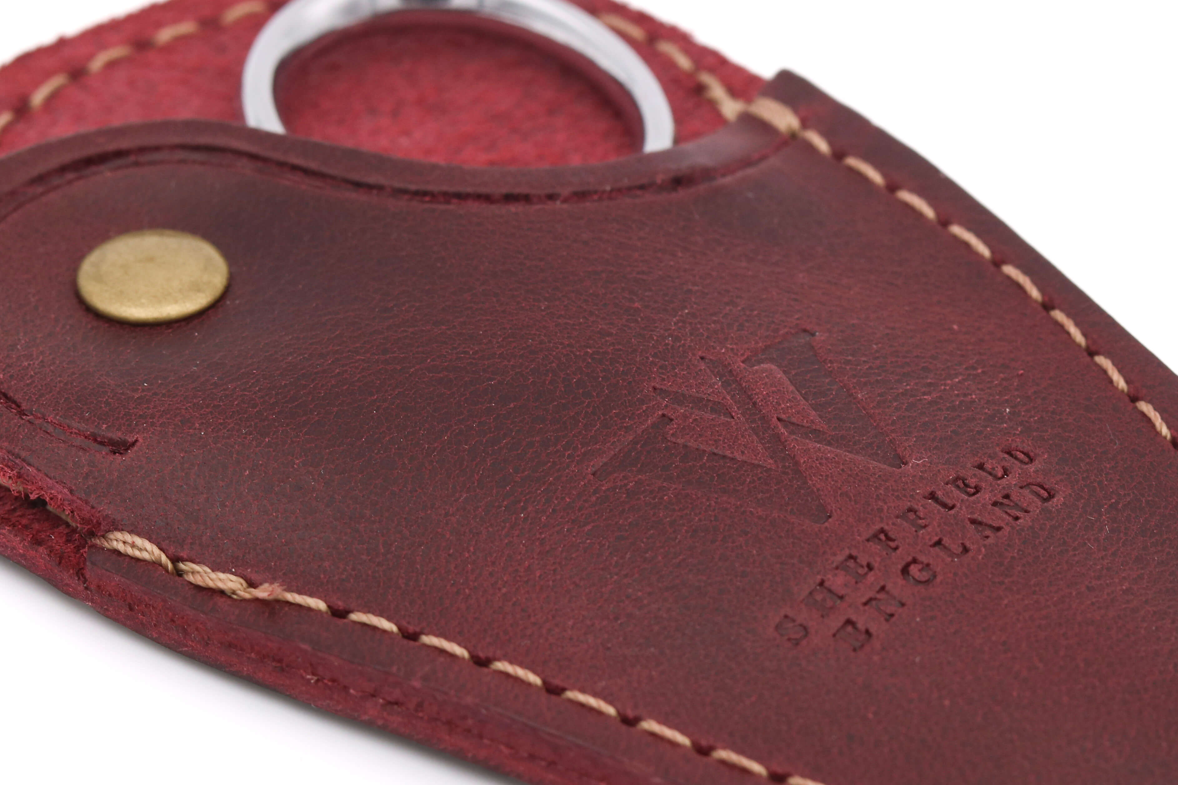 Close-up of vegetable-tanned oxblood leather on a handmade embroidery scissor sheath